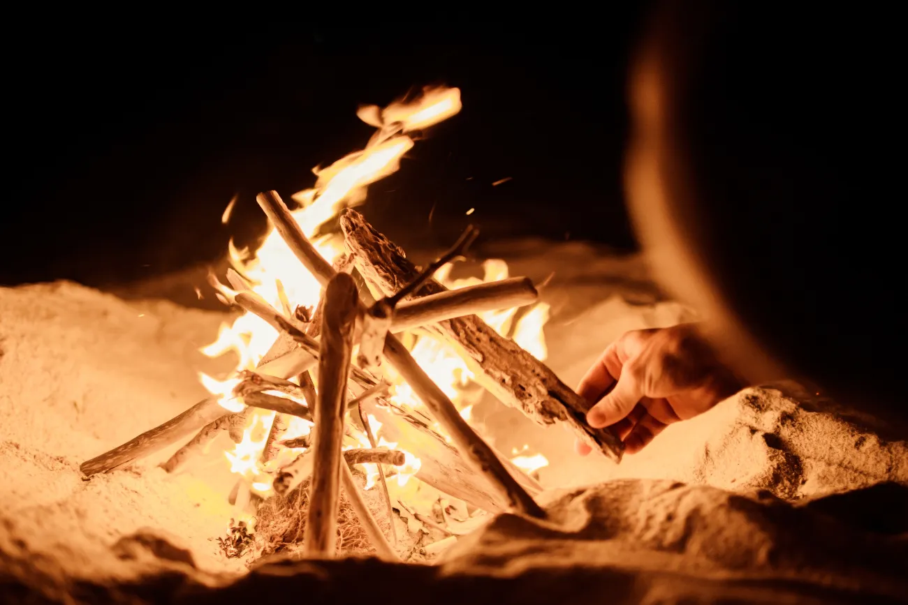 Lighting a fire on the beach