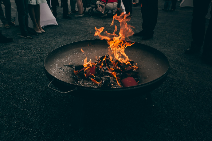 Live fire cooking over a fire pit