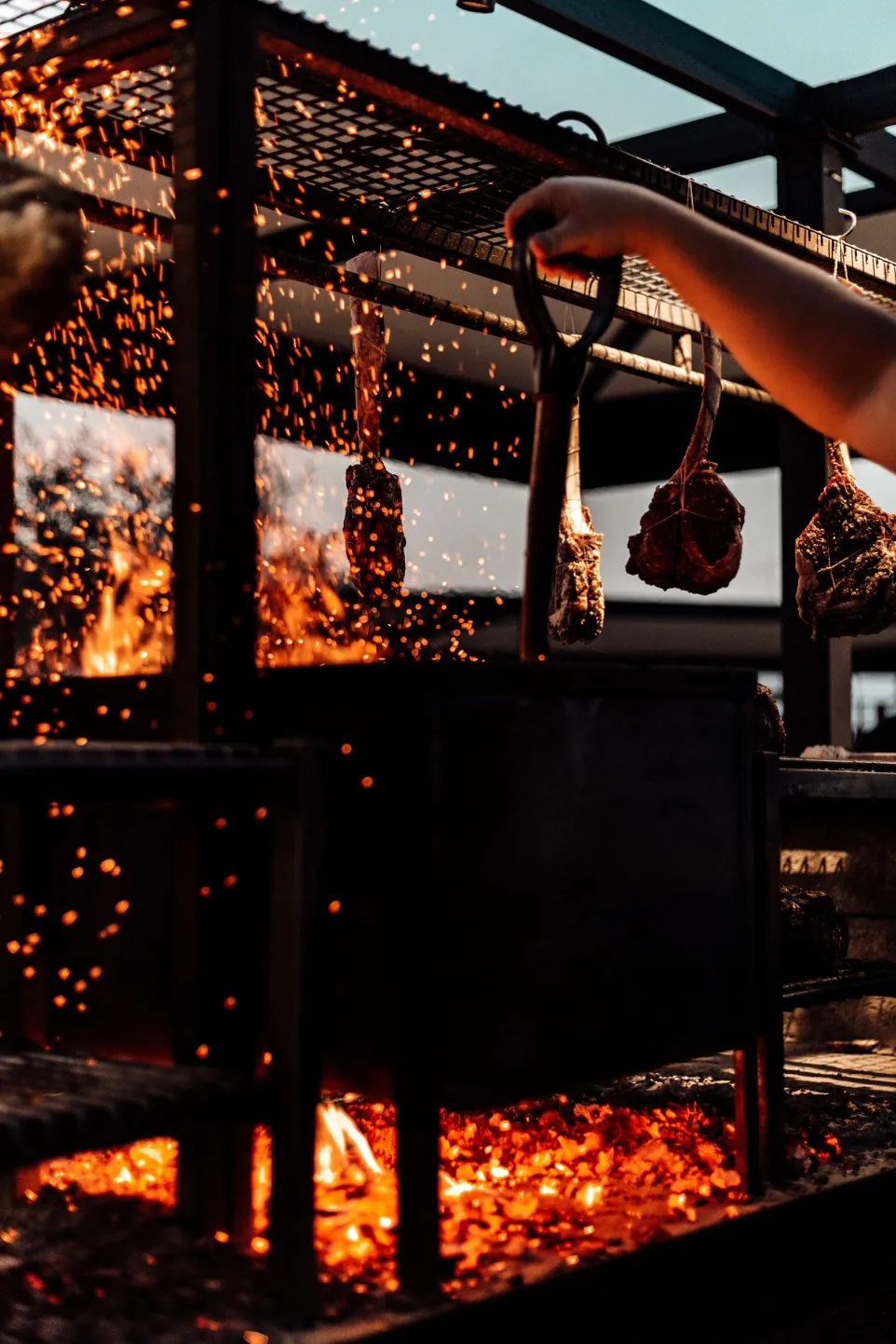 Meat roasting over glowing charcoal embers