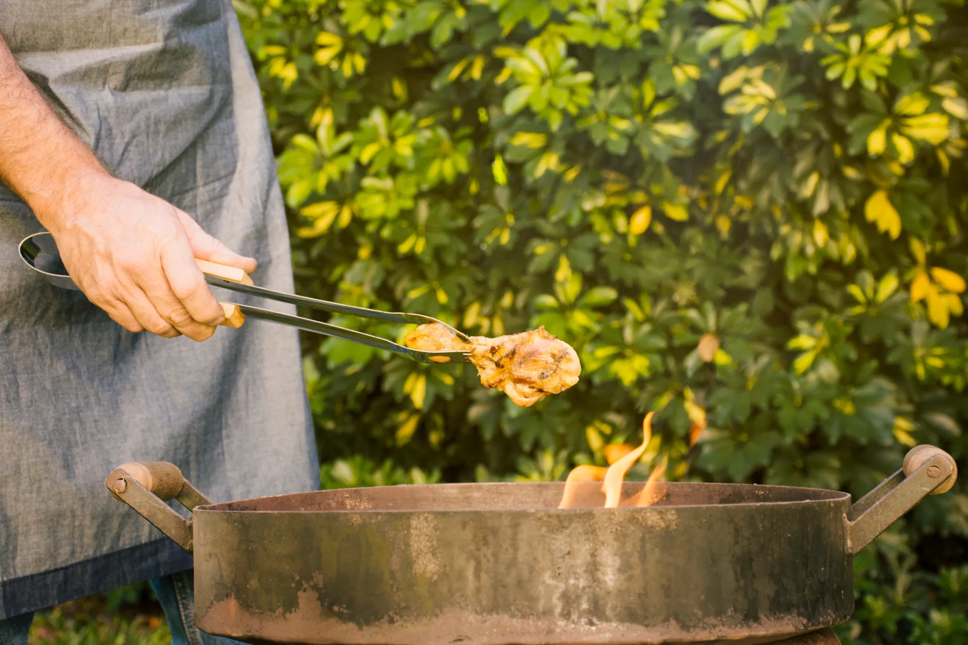 Grilling with Saborr BBQ tongs over a charcoal fire