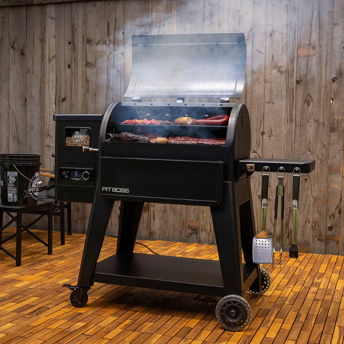 Pit Boss Navigator Series premium horizontal pellet grill with open lid smoking meat and sausages