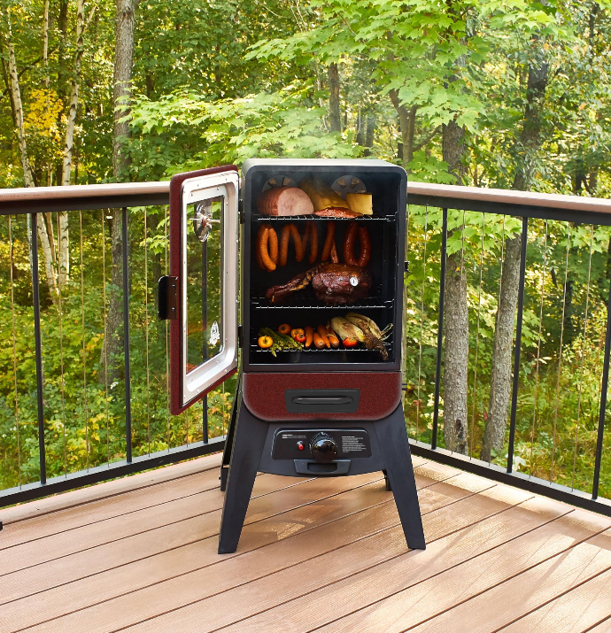 Upright Pit Boss vertical smoker with glass door open showing meat and sausages smoking on multiple racks